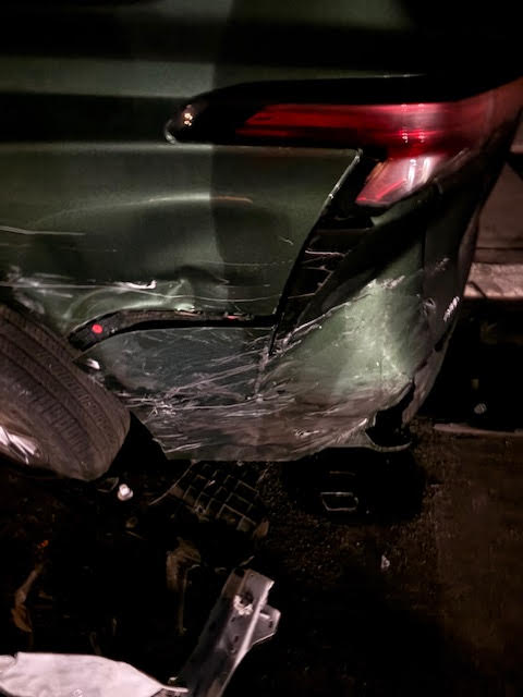 Rear quarter panel damage on a green Toyota Sienna